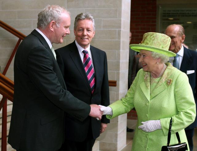 Queen Elizabeth shakes hands with Northern Ireland deputy first minister Martin McGuinness, watched by first minister Peter Robinson | © REUTERS / Alamy Stock Photo
