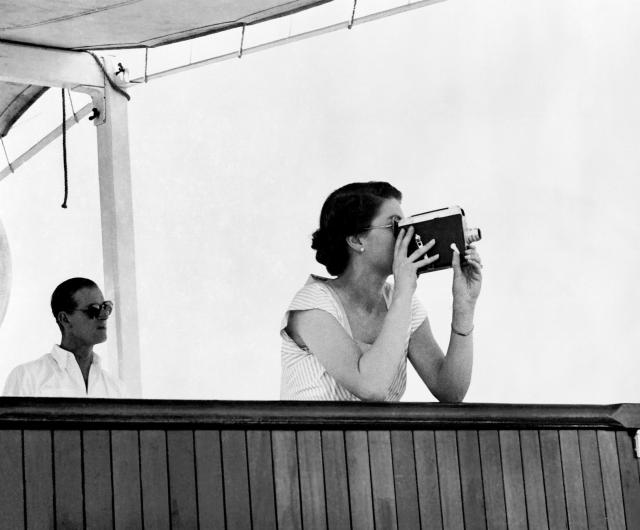 The Queen taking a cine-film of the historic hand-over of escort duty from the cruiser Sheffield, which was returning to Panama, to the New Zealand light cruiser Black Prince | © PA Images / Alamy Stock Photo